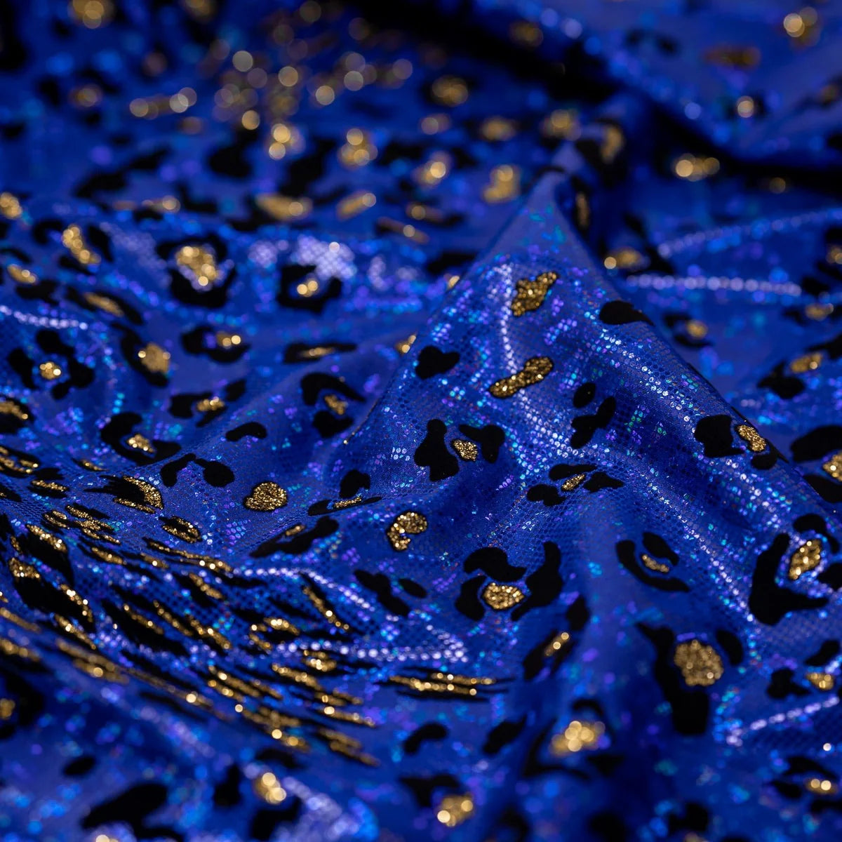 Close-up of blue fabric with gold and black patterns