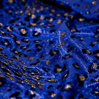 Close-up of blue fabric with gold and black patterns