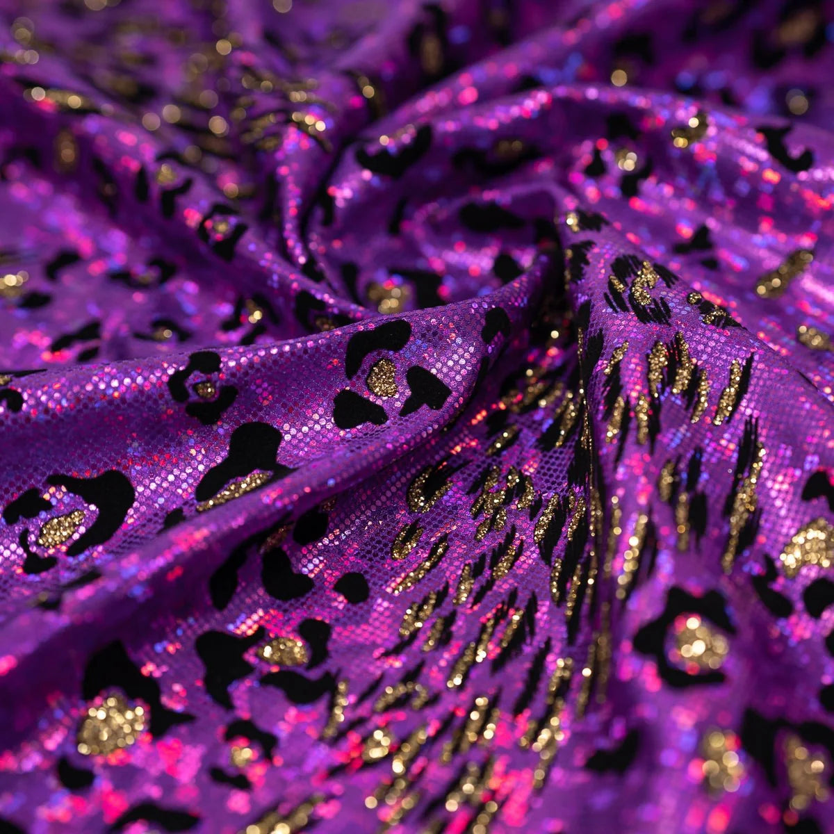 Close-up of purple fabric with black and gold patterns