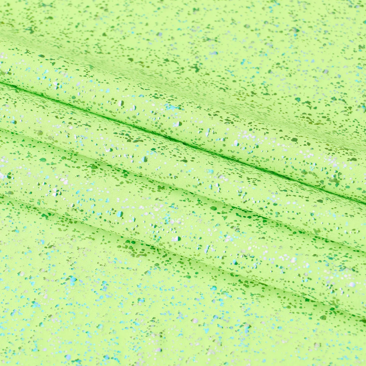 Close-up of a textured green fabric with speckles